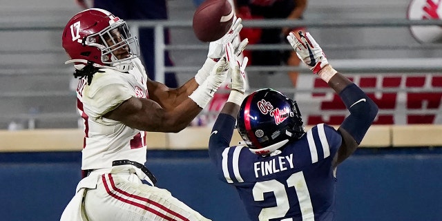 Alabama wide receiver Jaylen Waddle (17) pulls in a pass over Mississippi defensive back A.J. Finley (21) during the second half of an NCAA college football game in Oxford, Miss., Saturday, Oct. 10, 2020. Alabama won 63-48. (AP Photo/Rogelio V. Solis)