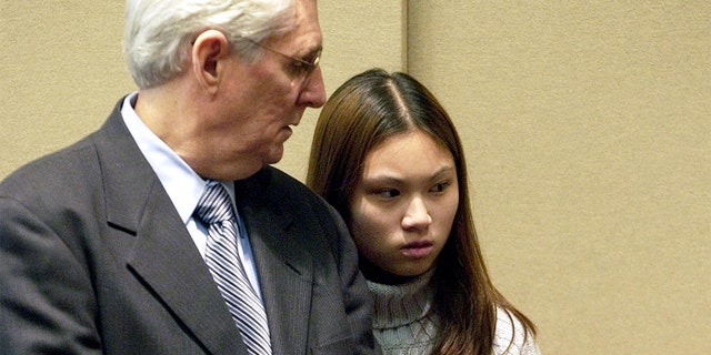 Attorney Joseph Krowski, Sr., of Brockton, Mass., has brief words with his client, Frances Choy, 17, of Brockton, Mass., during her arraignment in the Brockton District Court on two counts of murder, Friday, April 18, 2003. (AP Photo/Robert E. Klein)