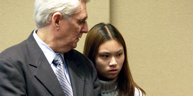 Attorney Joseph Krowski, Sr., of Brockton, Mass., has brief words with his client, Frances Choy, 17, of Brockton, Mass., during her arraignment in the Brockton District Court on two counts of murder, Friday, April 18, 2003. (AP Photo/Robert E. Klein)