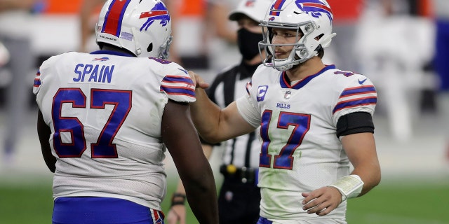 Buffalo Bills quarterback Josh Allen (17) celebrates with offensive guard Quinton Spain after defeating the Las Vegas Raiders in an NFL football game, Sunday, Oct. 4, 2020, in Las Vegas. The Bills won 30-23. (AP Photo/Isaac Brekken)