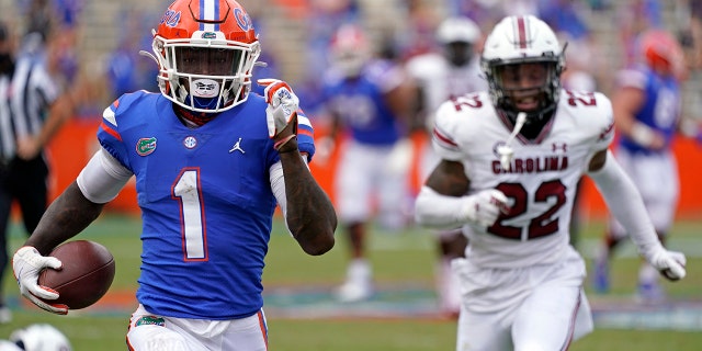 Florida wide receiver Kadarius Toney (1) gets past South Carolina defensive back John Dixon (22) for a 57-yard touchdown run during the second half of an NCAA college football game, Saturday, Oct. 3, 2020, in Gainesville, Fla. (AP Photo/John Raoux, Pool)