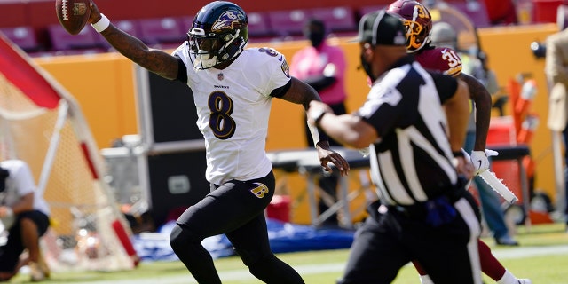 Baltimore Ravens quarterback Lamar Jackson (8) runs to the end zone for a touchdown against the Washington Football Team during the first half of an NFL football game, Sunday, Oct. 4, 2020, in Landover, Md. (AP Photo/Susan Walsh)