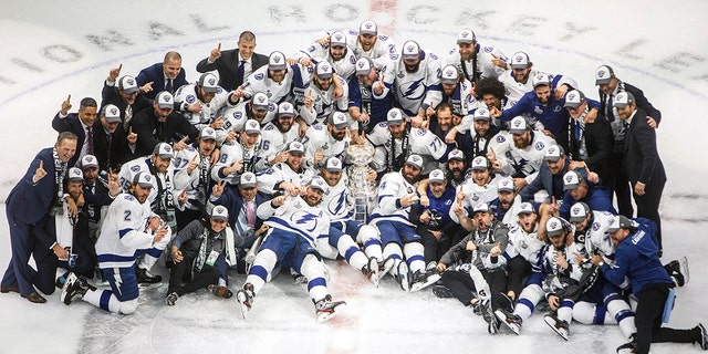 Tampa Bay Lightning players celebrate their Stanley Cup win over the Dallas Stars at the NHL Stanley Cup hockey finals in Edmonton, Alberta, on Monday, Sept. 28, 2020. (Jason Franson/The Canadian Press via AP)