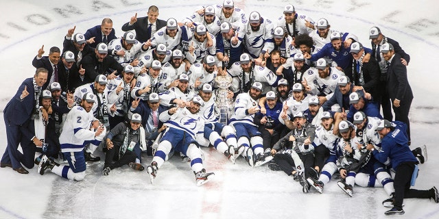 Tampa Bay Lightning players celebrate their Stanley Cup win over the Dallas Stars at the NHL Stanley Cup hockey finals in Edmonton, Alberta, on Monday, Sept. 28, 2020. (Jason Franson/The Canadian Press via AP)