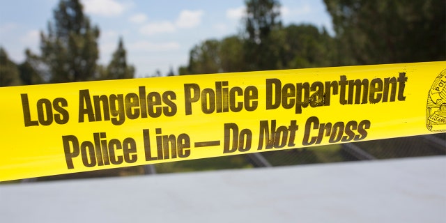 Yellow tape surrounds a crime scene in Los Angeles.