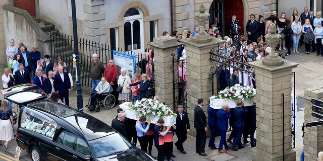 The coffins of Chloe Rutherford and Liam Curry, who were killed in the Manchester Arena bombing, arrive at St Hilda's Church, for their funeral service in South Shields, South Tyneside, Britain June 15, 2017. REUTERS/Danny Lawson/Pool