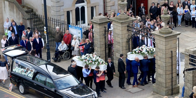 The coffins of Chloe Rutherford and Liam Curry, who were killed in the Manchester Arena bombing, arrive at St Hilda's Church, for their funeral service in South Shields, South Tyneside, Britain June 15, 2017. REUTERS/Danny Lawson/Pool