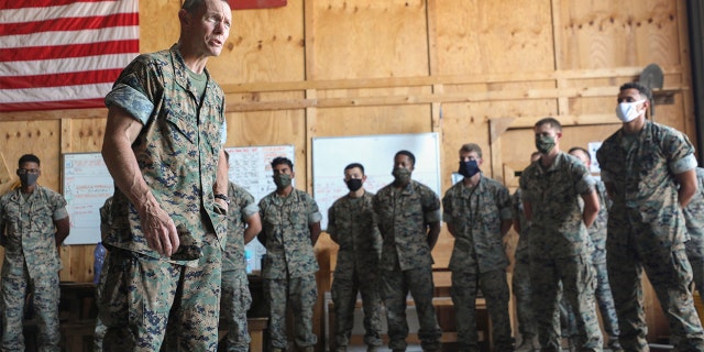 In this July 27, photo provided by the Defense Visual Information Distribution Service; DIVIDS, U.S. Marine Maj. Gen. Stephen M. Neary, Marine Forces Europe and Africa commander, left, speaks to Marines with Special Purpose Marine Air-Ground Task Force-Crisis Response-Africa 20.2, MARFOREUR/AF during a visit to Morόn Air Base, Spain. (U.S. Marine Corps photo by Cpl. Tawanya Norwood via AP)