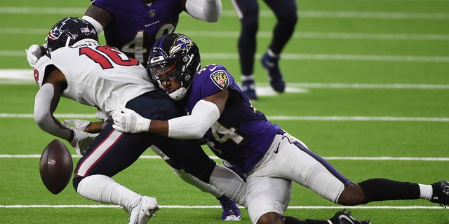 Baltimore Ravens cornerback Marlon Humphrey (44) causes Houston Texans wide receiver Keke Coutee (16) to fumble during the first half of an NFL football game Sunday, Sept. 20, 2020, in Houston. Baltimore recovered and scored a touchdown on the play. (AP Photo/Eric Christian Smith)