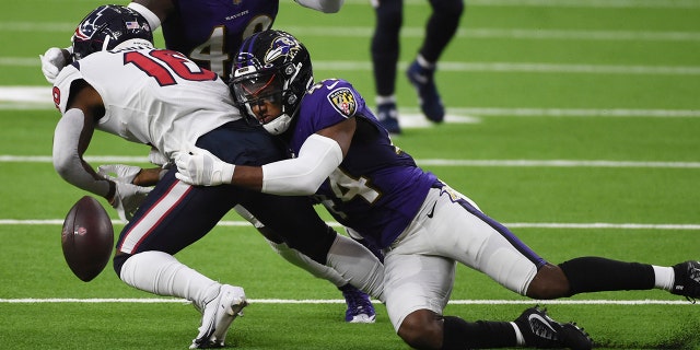 Baltimore Ravens cornerback Marlon Humphrey (44) causes Houston Texans wide receiver Keke Coutee (16) to fumble during the first half of an NFL football game Sunday, Sept. 20, 2020, in Houston. Baltimore recovered and scored a touchdown on the play. (AP Photo/Eric Christian Smith)