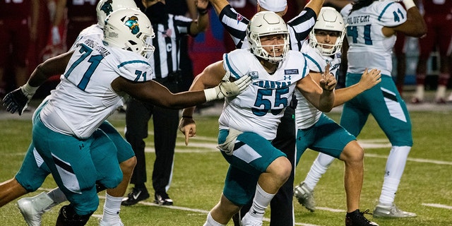 Coastal Carolina players celebrate after place kicker Massimo Biscardi (29) kicked the go-ahead and eventual game-winning field goal during the second half of an NCAA college football game against Louisiana-Lafayette in Lafayette, La., Wednesday, Oct. 14, 2020. (AP Photo/Paul Kieu)