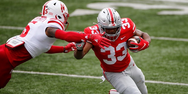 Nebraska defensive back Cam Taylor-Britt, left, forces Ohio State running back Master Teague out of bounds during the first half of an NCAA college football game Saturday, Oct. 24, 2020, in Columbus, Ohio. (AP Photo/Jay LaPrete)