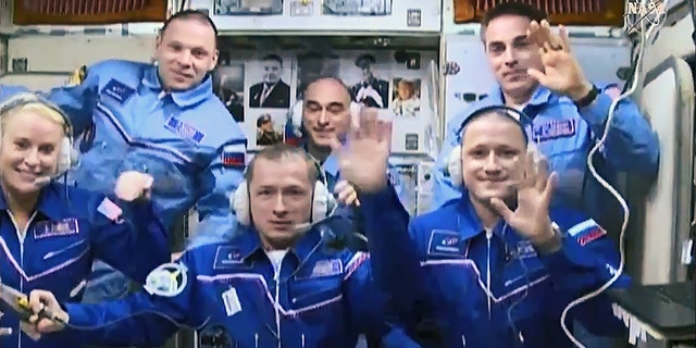 (Front row from left) Expedition 64 crew members Kate Rubins, Sergey Ryzhikov and Sergey Kud-Sverchkov join Expedition 63 crew members (back row from left) Ivan Vagner, Anatoly Ivanishin and Chris Cassidy inside the space station's Zvezda service module. (Front row from left) Expedition 64 crew members Kate Rubins, Sergey Ryzhikov and Sergey Kud-Sverchkov join Expedition 63 crew members (back row from left) Ivan Vagner, Anatoly Ivanishin and Chris Cassidy shortly after the Soyuz capsule's arrival on Oct. 14, 2020.