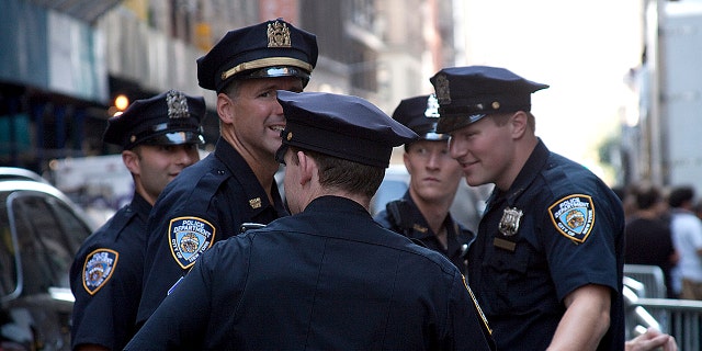A group of New York police officers (NYPD) talking on the street during the winter on Feb.16, 2012. (iStock)