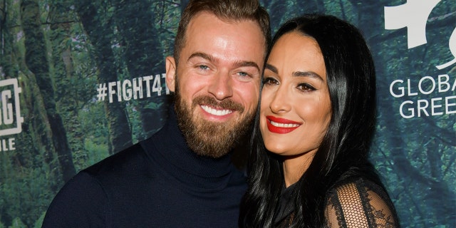 Artem Chigvintsev (L) and Nikki Bella will tie the knot in November 2021.