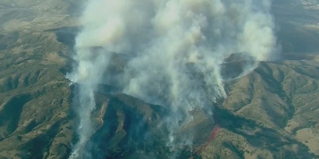 The Silverado Fire rapidly grew to 2,000 acres Monday in Orange County, Calif., driven by gusty winds.