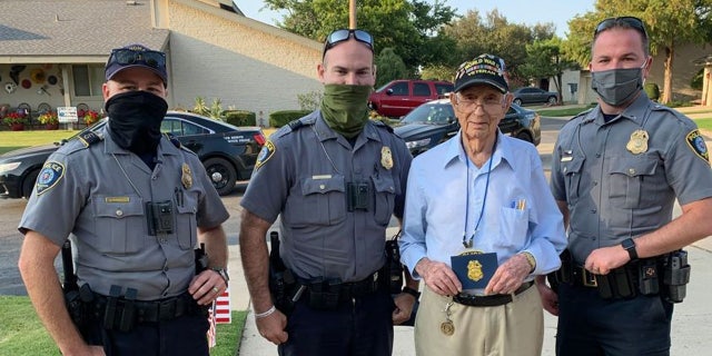 Oklahoma City police officers stopped to celebrate Raymond Duncan's 100th birthday on Monday.