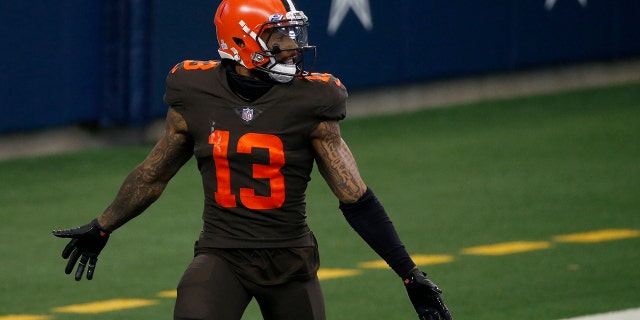 Cleveland Browns wide receiver Odell Beckham Jr. (13) celebrates after scoring a touchdown against the Dallas Cowboys late in the second half of an NFL football game in Arlington, Texas, Sunday, Oct. 4, 2020. (AP Photo/Michael Ainsworth)