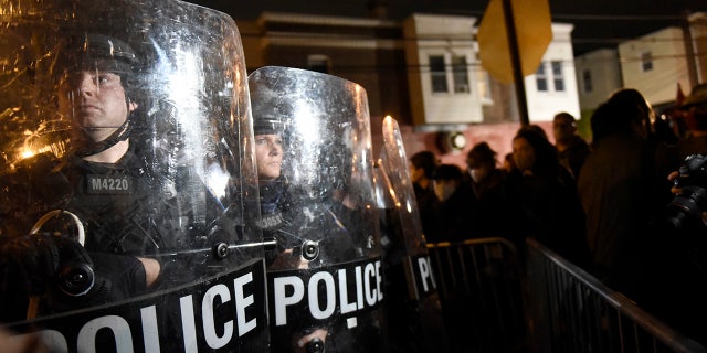 Philadelphia police officers form a line during a demonstration in Philadelphia, late Tuesday, Oct. 27, 2020. (AP Photo/Michael Perez)