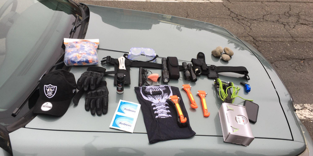 Police found window punch tools, pepper spray, throwing knives, a laser pointer, a slingshot, rocks, and other items, which were all seized as evidence.