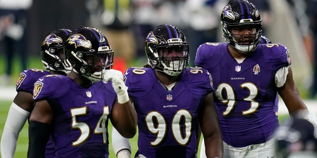 Baltimore Ravens defenders Pernell McPhee (90) Calais Campbell (93) prepare for the next play during an NFL football game against the Houston Texans, Sunday, Sept. 20, 2020, in Houston. (AP Photo/Matt Patterson)