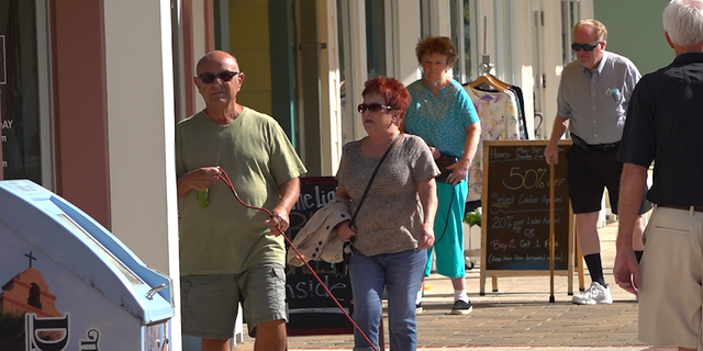 Residents of The Villages retirement community walking around the Lake Sumter Landing area. Senior citizens make up over 20% of Florida's population according to 2019 Census estimates (Robert Sherman, Fox News).