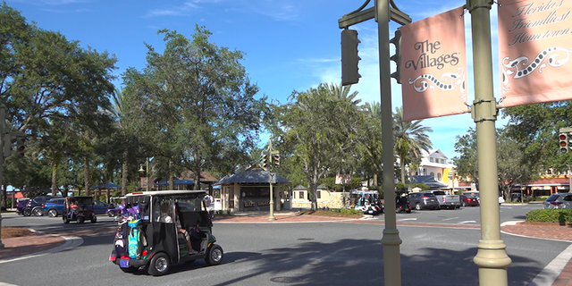 Golf carts zip around Lake Sumter Landing in The Villages (Robert Sherman, Fox News).