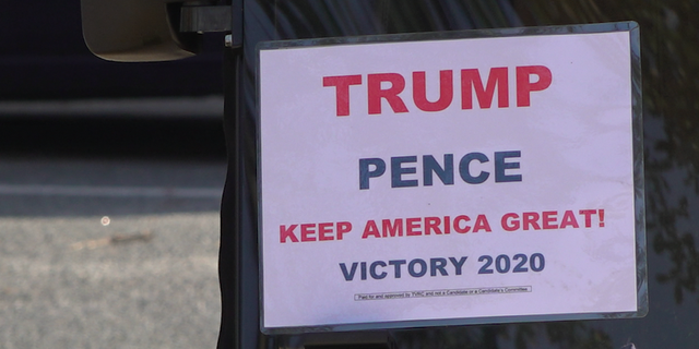 A sign expressing support for President Trump hanging from the front of a golf cart in The Villages (Robert Sherman, Fox News)