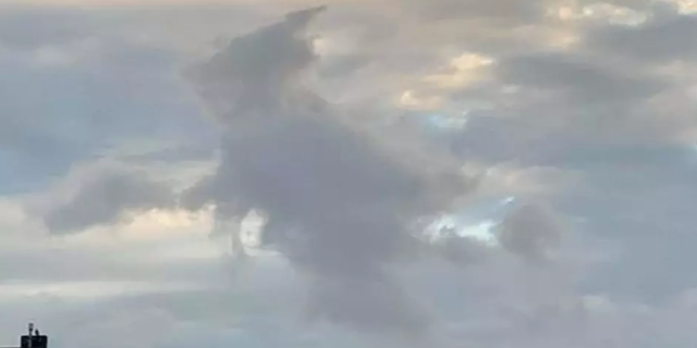 An outline of a witch in the clouds above Florida.