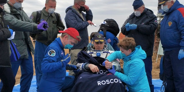 In this photo released by Rosaviatsiya, NASA astronaut Chris Cassidy sits in a chair shortly after the landing near town of Dzhezkazgan, Kazakhstan, Thursday, Oct. 22, 2020.
