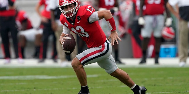 Georgia quarterback Stetson Bennett (13) scrambles against Tennessee Oct. 10, 2020, in Athens, Ga. 