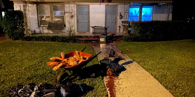 A Texas artist claims his home has become a frequent stop for local police, after going all-out to transform his front yard into a stomach-churning murder scene for Halloween.