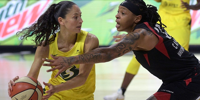 Seattle Storm guard Sue Bird (10) is defended by Las Vegas Aces forward Emma Cannon (32) during the second half of Game 2 of basketball's WNBA Finals, Sunday, Oct. 4, 2020, in Bradenton, Fla. (AP Photo/Phelan M. Ebenhack)