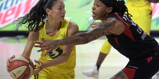 Seattle Storm guard Sue Bird (10) is defended by Las Vegas Aces forward Emma Cannon (32) during the second half of Game 2 of basketball's WNBA Finals, Sunday, Oct. 4, 2020, in Bradenton, Fla. (AP Photo/Phelan M. Ebenhack)