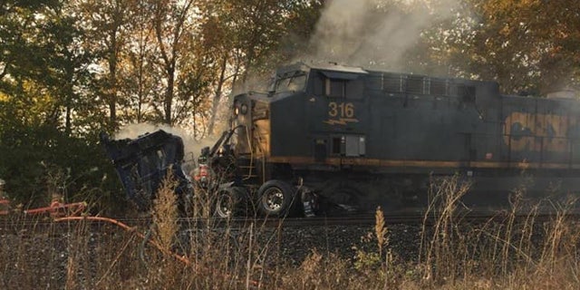 Train slams semi-truck in Indiana after driver gets stuck on tracks 2 The aftermath after a freight train ran into a semi-truck that was stuck on the tracks in Pendleton, Ind. on October 9, 2020.