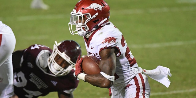 Arkansas running back Trelon Smith (22) carries the ball during the second half of the team's NCAA college football game against Mississippi State in Starkville, Miss., Saturday, Oct. 3, 2020. Arkansas won 21-14. (AP Photo/Thomas Graning)