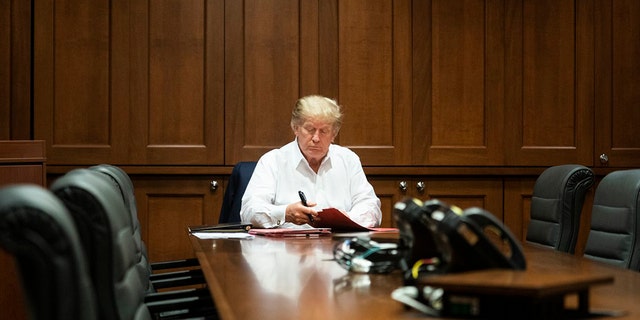 President Trump photographed working from a conference room at Walter Reed National Military Medical Center on Saturday, Oct. 3, 2020, after testing positive for the coronavirus.