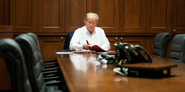 President Trump photographed working from a conference room at Walter Reed National Military Medical Center on Saturday, Oct. 3, 2020, after testing positive for the coronavirus.