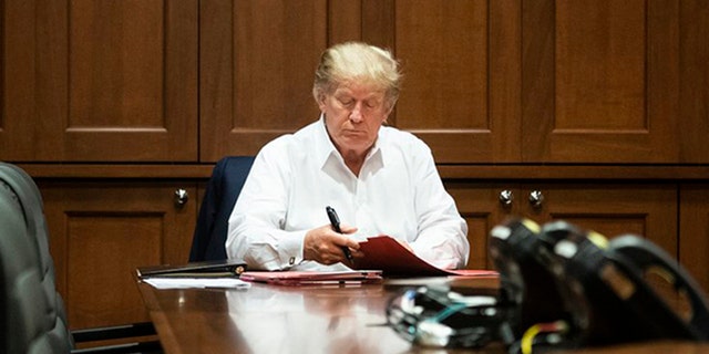 President Trump photographed working from a conference room at Walter Reed National Military Medical Center on Saturday, Oct. 3, 2020, after testing positive for the coronavirus.