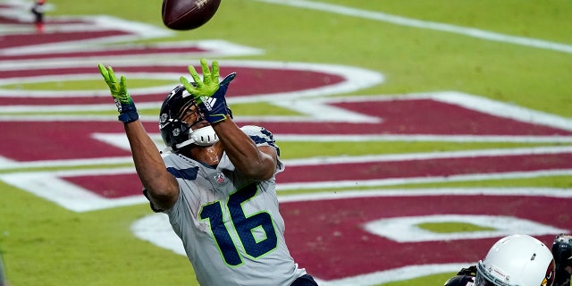 Seattle Seahawks wide receiver Tyler Lockett (16) pulls in a touchdown pass as Arizona Cardinals cornerback Dre Kirkpatrick (20) defends during the second half of an NFL football game, Sunday, Oct. 25, 2020, in Glendale, Ariz. (AP Photo/Ross D. Franklin)