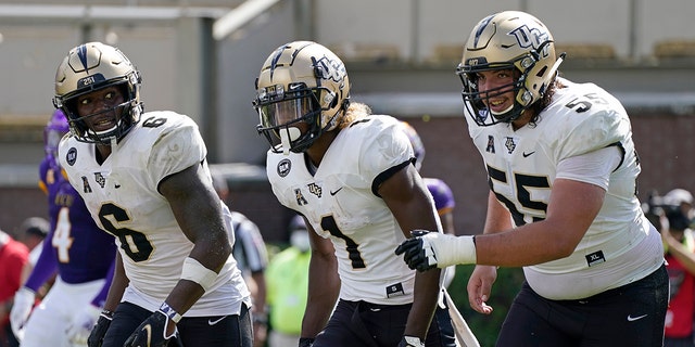 Central Florida wide receiver Marlon Williams (6), wide receiver Jaylon Robinson (1) and offensive lineman Matthew Lee (55) react following Robinson's touchdown against East Carolina during the second half of an NCAA college football game in Greenville, N.C., Saturday, Sept. 26, 2020. (AP Photo/Gerry Broome)