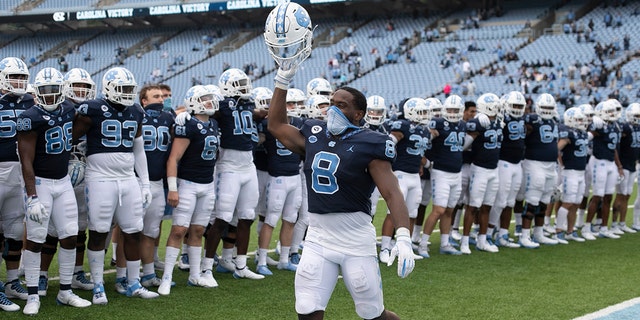 North Carolina's Michael Carter (8) leads the celebration following the Tar Heels' 56-49 victory over Virginia Tech in an NCAA college football game, Saturday, Oct. 10, 2020 at Kenan Stadium in Chapel Hill, N.C. (Robert Willett/The News &amp; Observer via AP)