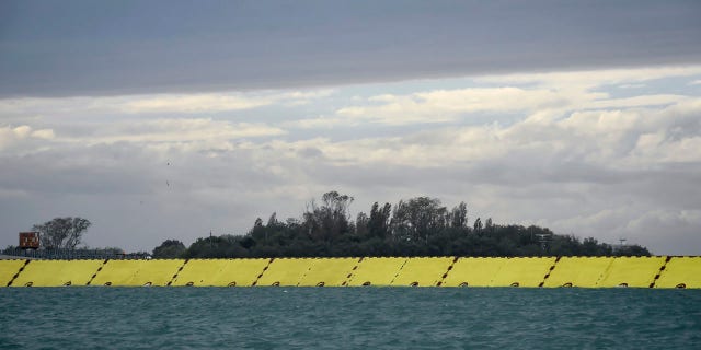 Yellow barriers are raised during high water in Venice, northern Italy, Saturday, Oct. 3, 2020.