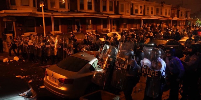 Police officers move in formation during a protest in response to the police shooting of Walter Wallace Jr., Monday, Oct. 26, 2020, in Philadelphia. (Jessica Griffin/The Philadelphia Inquirer via AP)