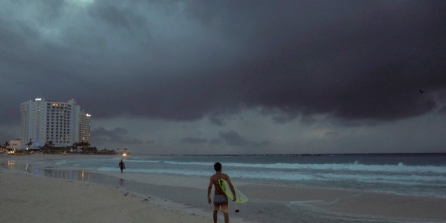 Clouds gather over Playa Gaviota Azul as Tropical Storm Zeta approaches Cancun, Mexico, early Monday morning, Oct. 26, 2020.