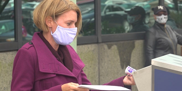 Amy Kennedy drops off her mail-in ballot in Atlantic City, N.J.