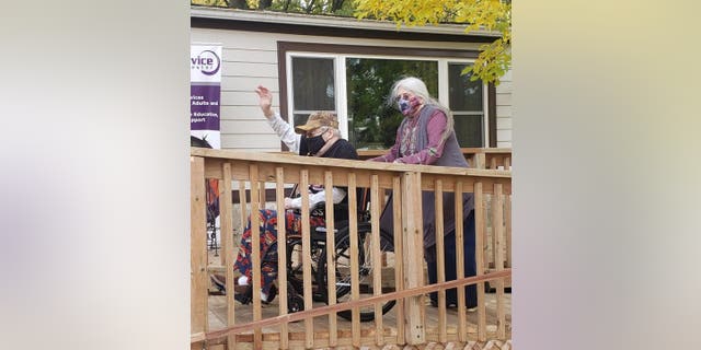 Navy vet Bob McReynolds waved outside his home in Rochester, Minnesota at the top of new ramp, built for him by two nonprofits to help him get around.