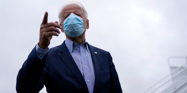 Democratic presidential candidate former Vice President Joe Biden speaks to members of the media before boarding his campaign plane at New Castle Airport, in New Castle, Del., Monday, Oct. 12, 2020, en route to Ohio. (AP Photo/Carolyn Kaster)