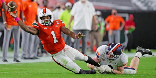 Miami quarterback D'Eriq King (1) is tackled by Virginia's Zane Zandier (1) in the first half of an NCAA college football game in Miami Gardens, Fla., Saturday, Oct. 24, 2020.