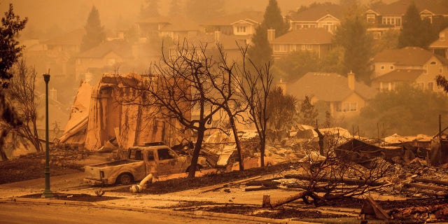 In this Sept. 28, 2020, file photo, houses leveled by the Glass Fire are viewed on a street in the Skyhawk neighborhood of Santa Rosa, Calif.
